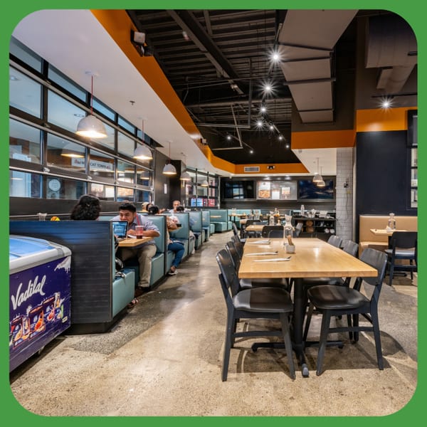 ID Cafe's spacious dining area with booths, tables, and customers, featuring modern industrial design.